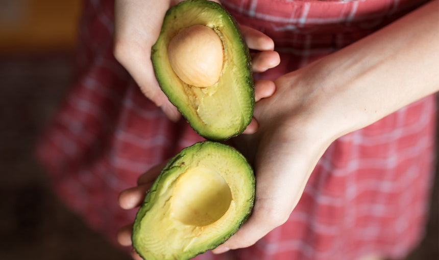 a-woman-holding-an-avocado