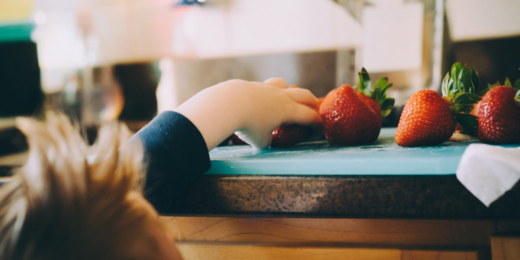 bare-biology-omega-3-a-child-reaching-for-a-fresh-strawberry