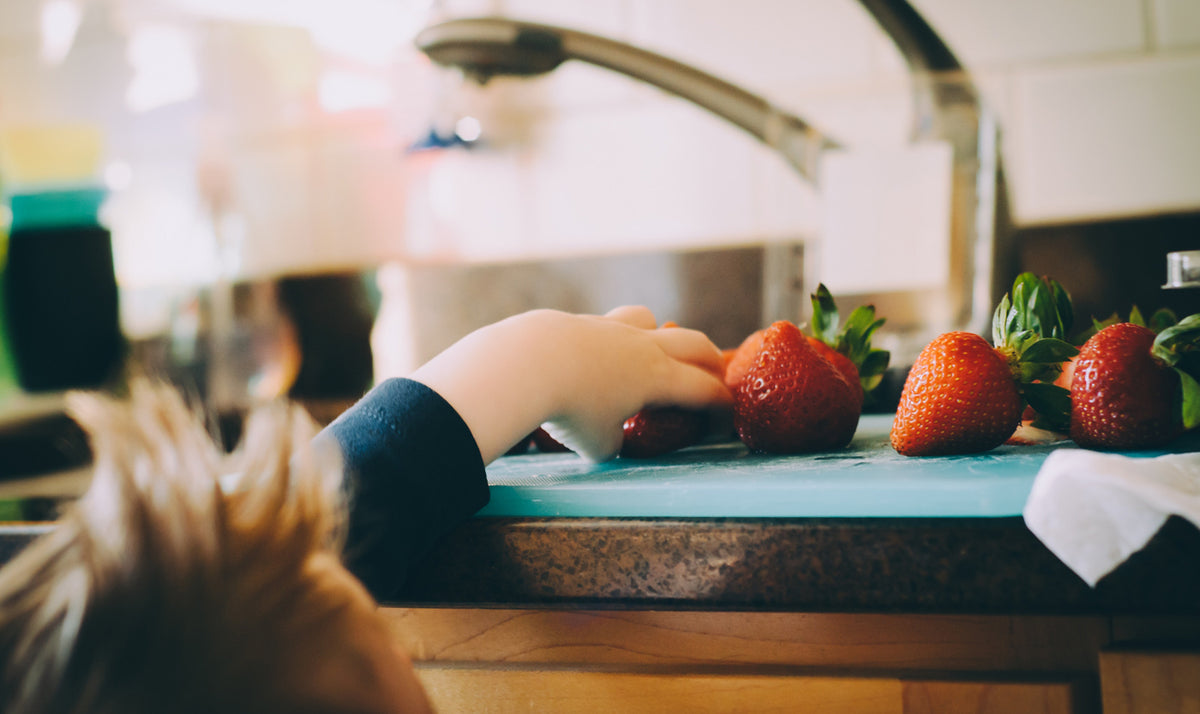 bare-biology-omega-3-a-little-boy-reaching-for-fresh-strawberries