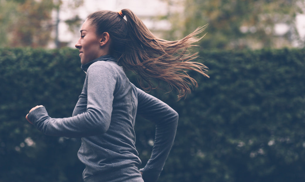 A woman jogging down the street