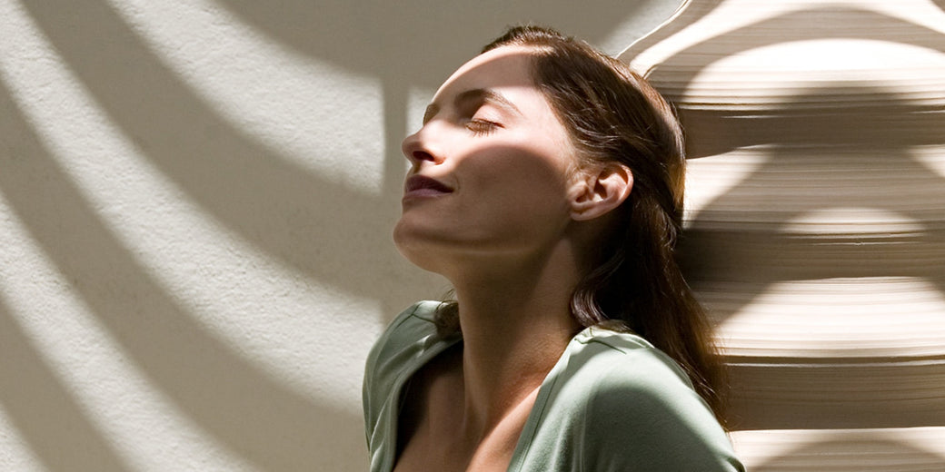 calm and happy woman sitting in the sun