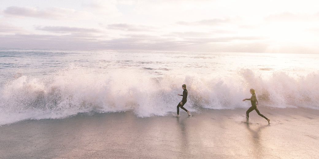 two people running into the sea