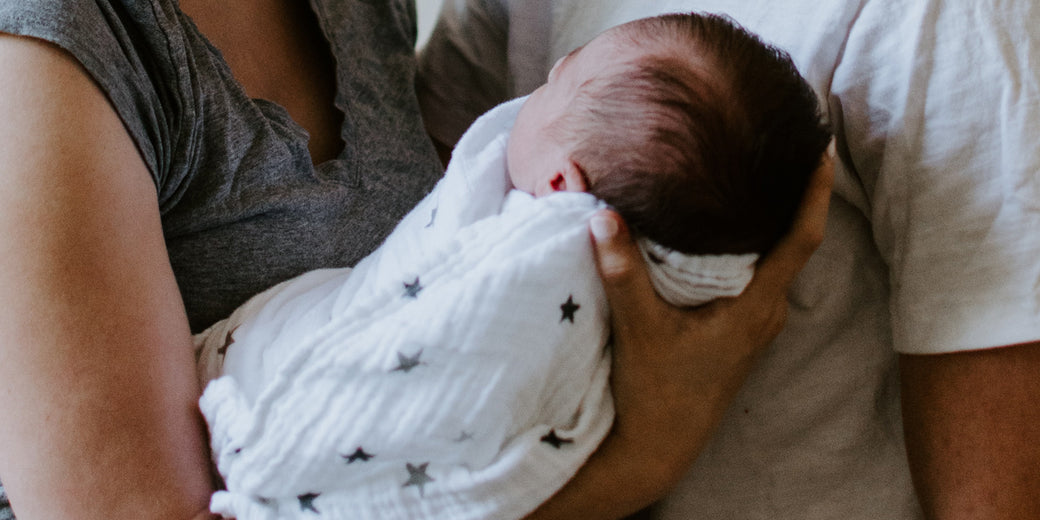 woman-holding-sleeping-baby