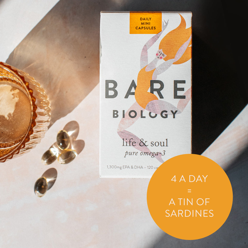 Bare Biology omega-3 mini capsules box on a table with sunny shadows and capsules. 4 a day = a tin of sardines 