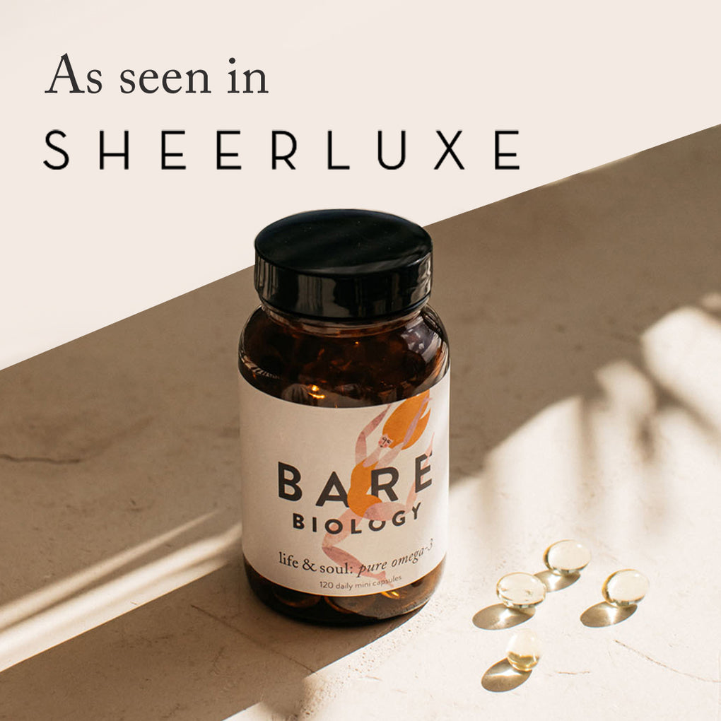 Bottle of life & soul mini capsules on a sunny table with 4 capsules and a press feature: as seen in Sheerluxe.