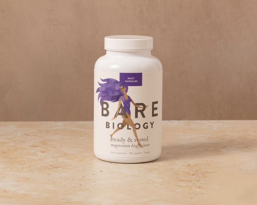 Jar of Bare Biology's Ready & Rested magnesium capsules on a stone table.